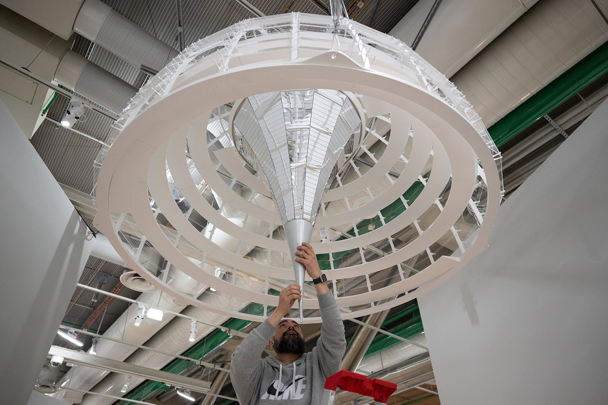 Adjusting the model of the Reichstag's cupola, where people ascend symbolically above the heads of their representatives in the chamber. The transformation of the Reichstag is rooted in four related issues: the Bundestag’s significance as a democratic forum, an understanding of history, a commitment to accessibility and a vigorous environmental agenda.
