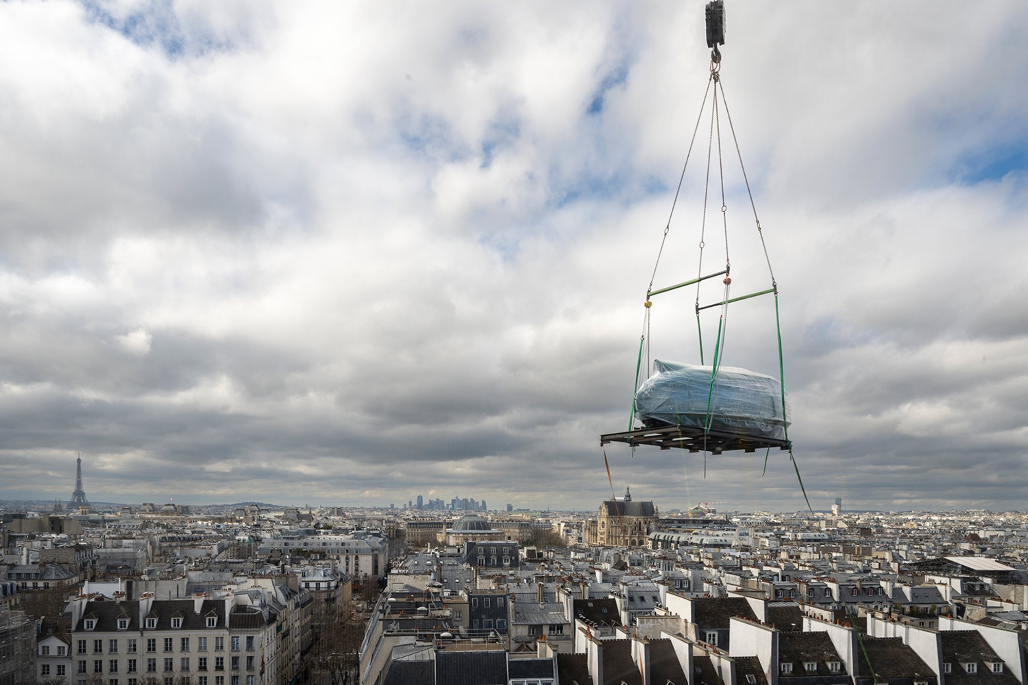 The Dymaxion Car #4 being lifted to the the 6th floor of the Centre Pompidou, using a crane. The car was elevated from the plaza in front of the building and took a day to install. Norman Foster created the fourth version of the 1934 Dymaxion automobile, in homage to the late Richard Buckminster Fuller, with whom he collaborated for the last twelve years of the American polymath's life.