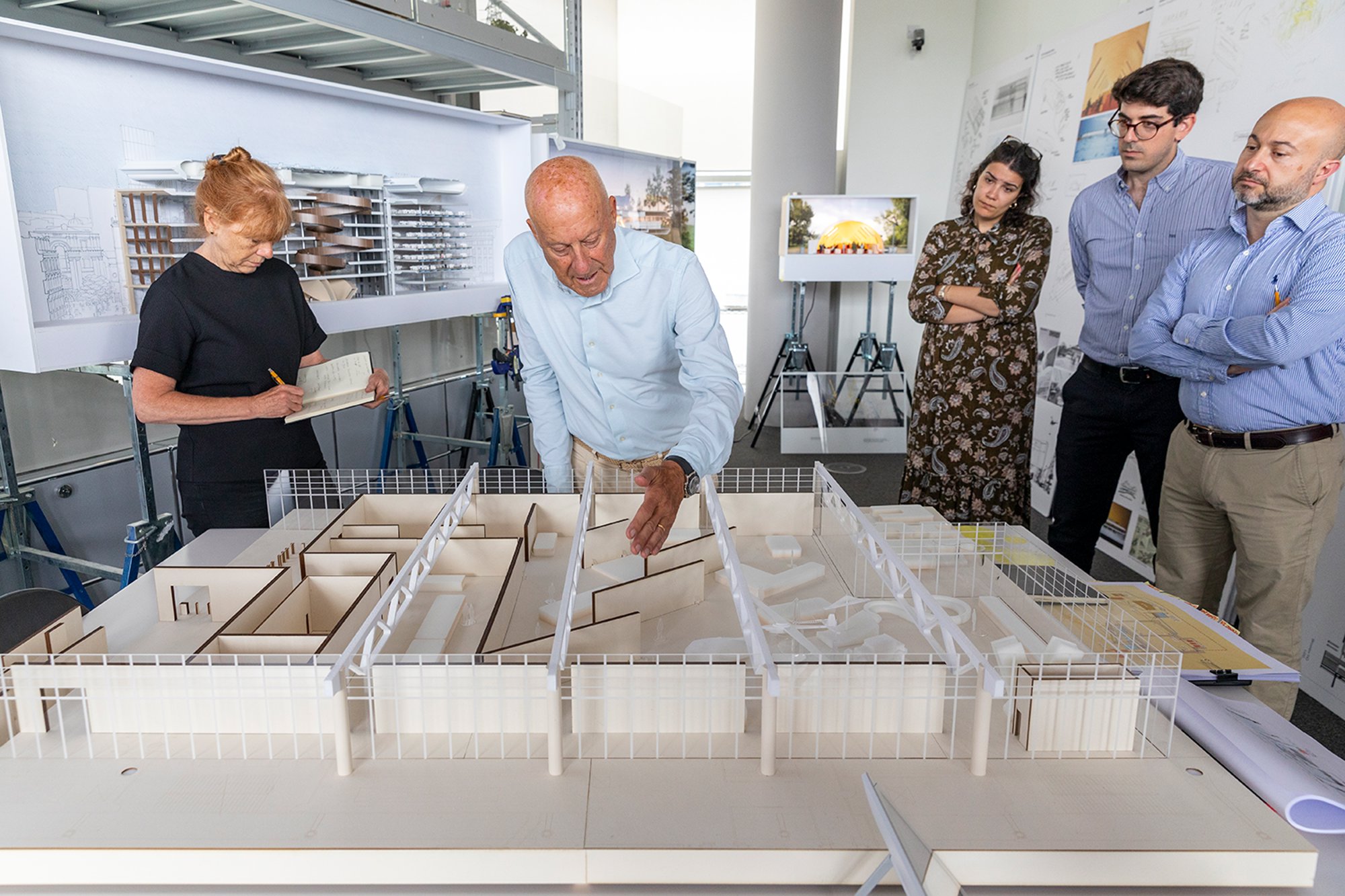 An early design review in the London studio, working with a model of the exhibition space to select locations for the dioramas, which bring a number of the practice's projects to life. A series of angled walls divide the exhibition space, generate views of the city skyline and provide vertical surfaces for display.